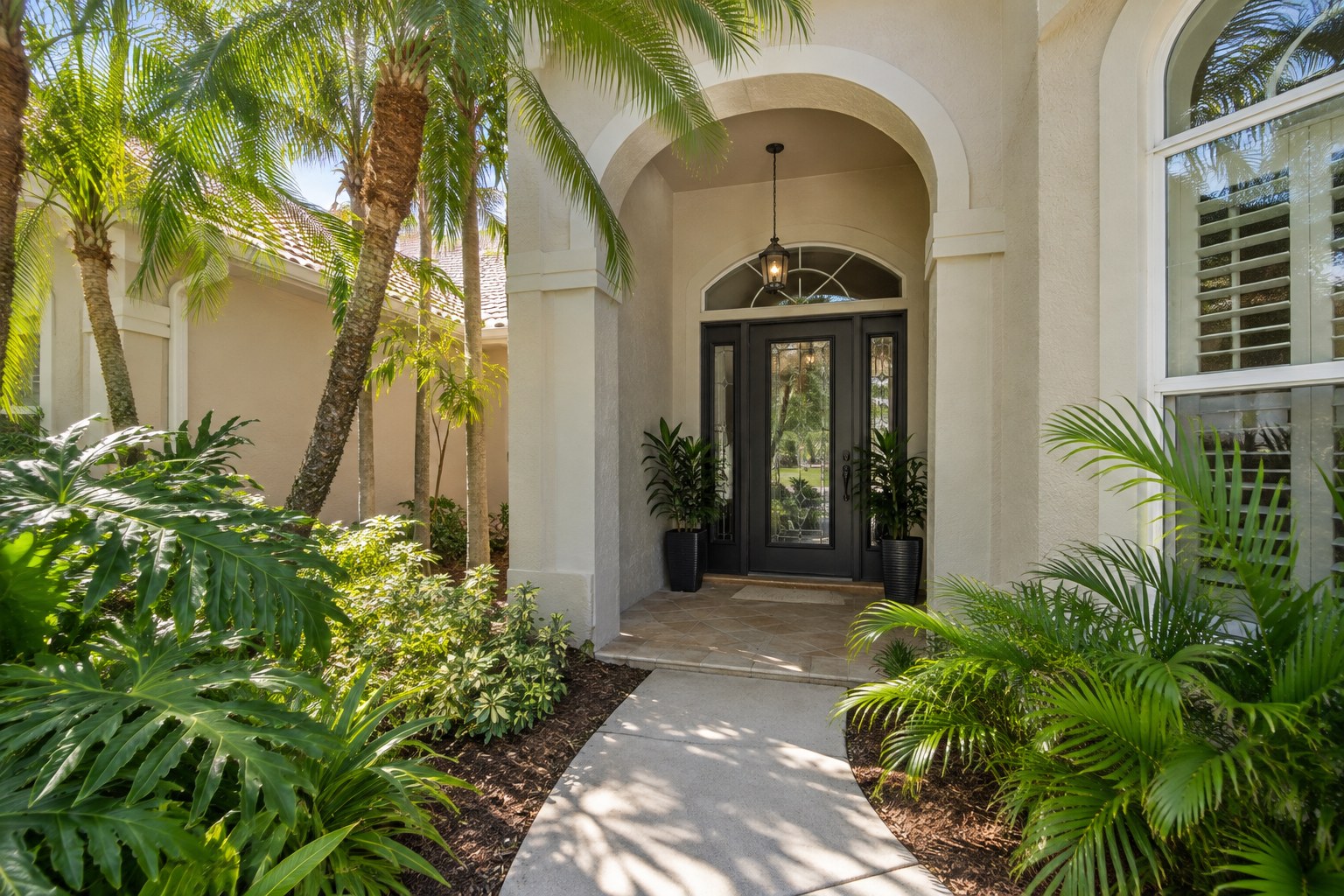 A shaded front entry of a Florida home, illustrative